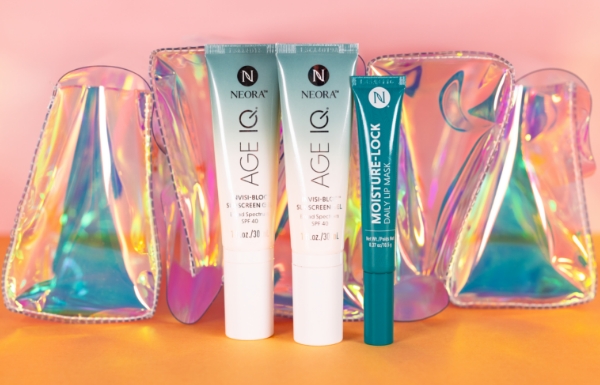 Summer Skin Essentials Set is shown on a pink ombre background including the FREE holographic travel bag. 